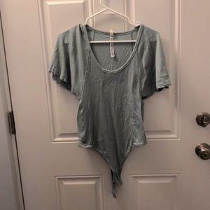 Dusty blue body suit with bellowing sleeves